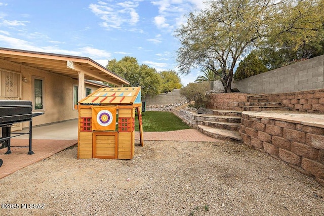 view of yard with a playground and a patio