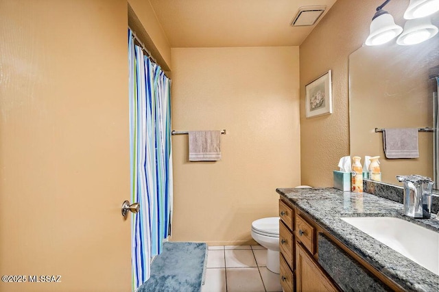 bathroom featuring tile patterned floors, vanity, and toilet