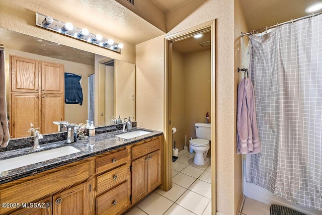 bathroom featuring tile patterned flooring, vanity, and toilet