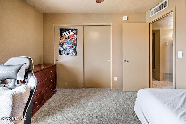 bedroom with light carpet and a closet