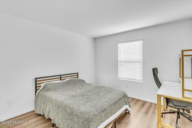 bedroom featuring light wood-style flooring and baseboards