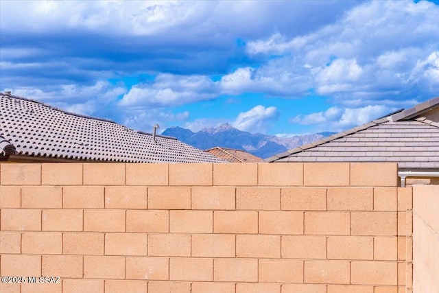 view of yard featuring fence and a mountain view