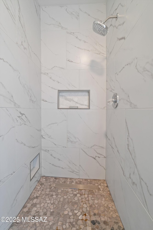 bathroom with a tile shower