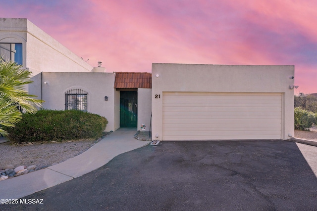 pueblo-style home featuring a garage