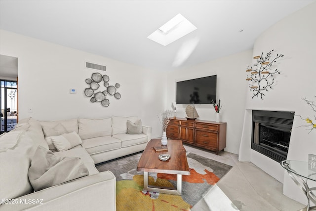 living room featuring a skylight