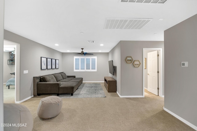 carpeted living room featuring ceiling fan