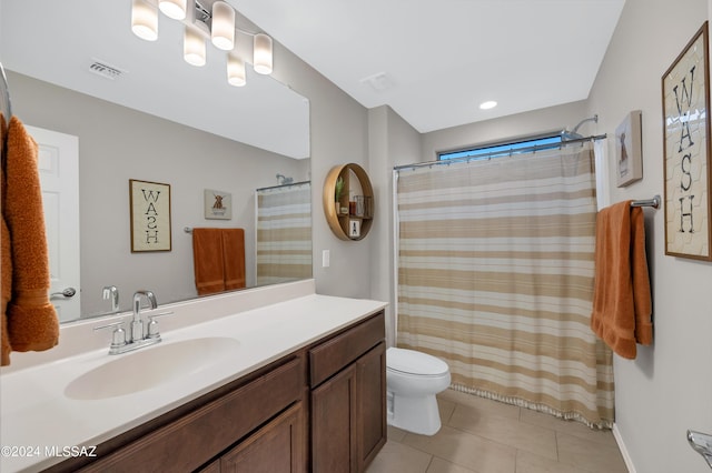 bathroom featuring tile patterned flooring, vanity, a shower with curtain, and toilet