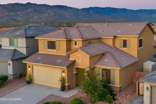 view of property with a garage and a mountain view