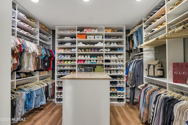 walk in closet with wood-type flooring