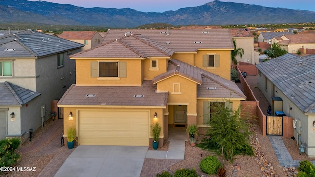 townhome / multi-family property with a garage and a mountain view