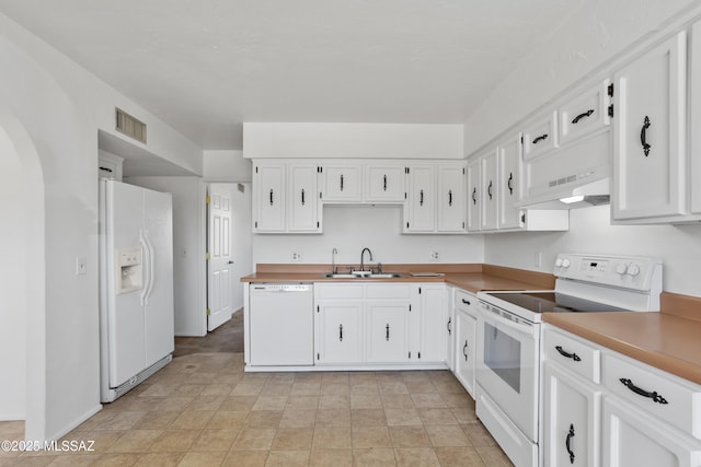 kitchen with custom exhaust hood, sink, white cabinets, and white appliances