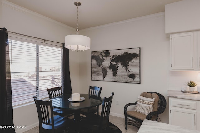 tiled dining space featuring ornamental molding