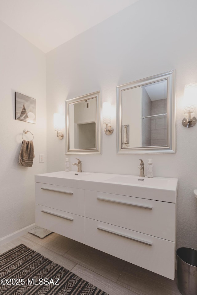 bathroom with vanity and a shower