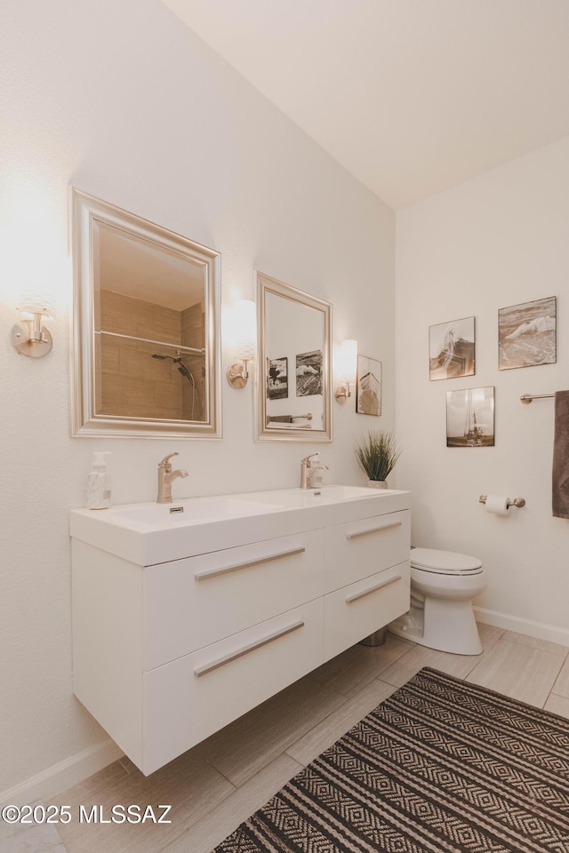 bathroom with vanity, toilet, and a shower