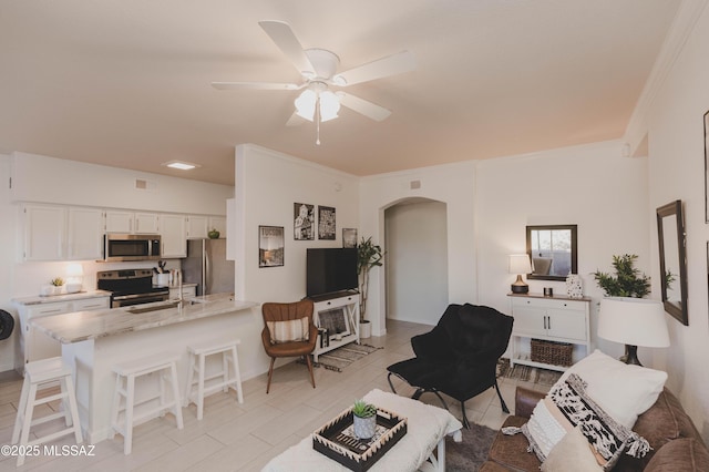 living room featuring crown molding and ceiling fan