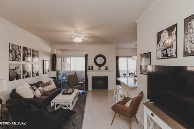 living room featuring ceiling fan and ornamental molding