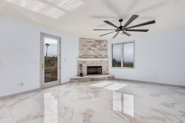 unfurnished living room with ceiling fan, ornamental molding, and a fireplace