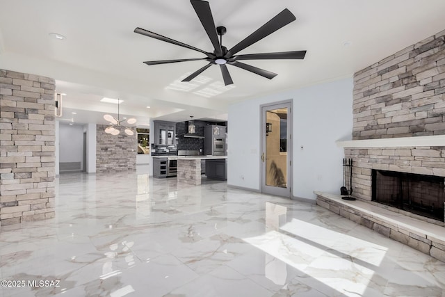 unfurnished living room featuring a fireplace and ceiling fan