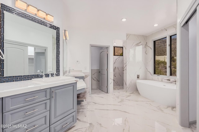 bathroom featuring vanity and separate shower and tub