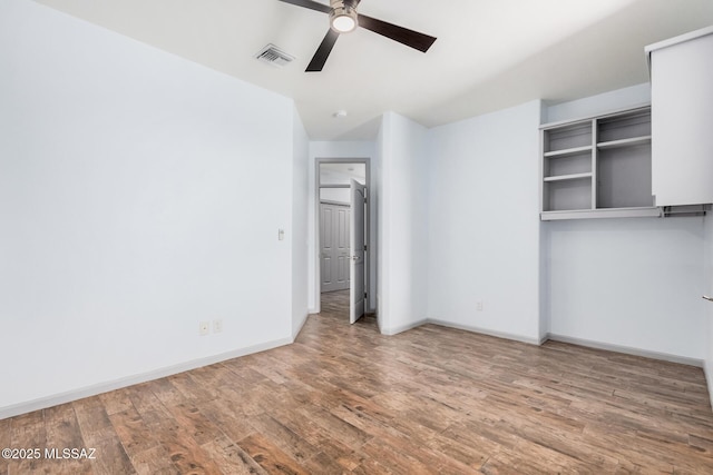 spare room with wood-type flooring and ceiling fan