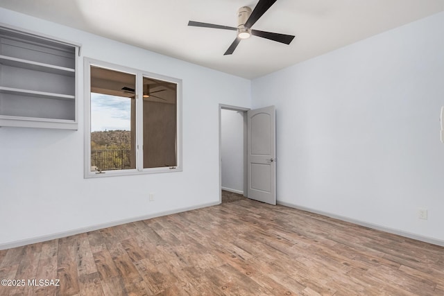 spare room featuring hardwood / wood-style flooring and ceiling fan