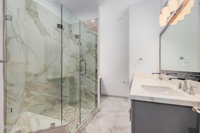 bathroom featuring a shower with door and vanity