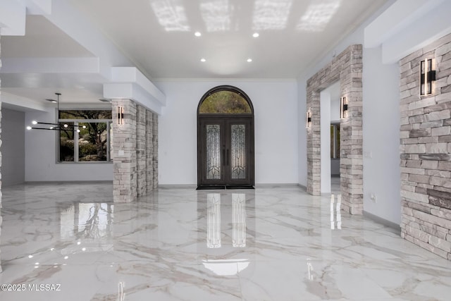 foyer featuring ornamental molding and french doors