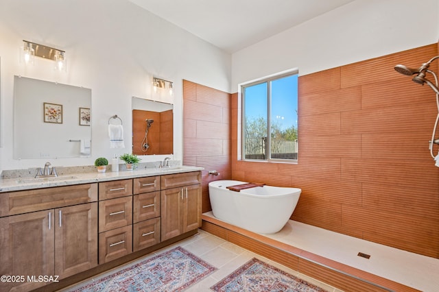 bathroom with tile patterned floors, shower with separate bathtub, and vanity