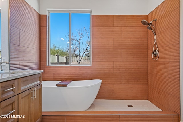 bathroom with vanity and shower with separate bathtub