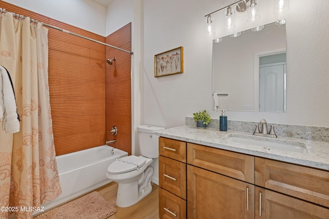 full bathroom with shower / tub combo, vanity, hardwood / wood-style flooring, and toilet