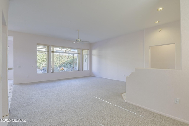 carpeted empty room featuring ceiling fan