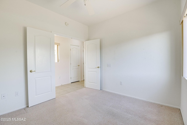 unfurnished bedroom featuring light colored carpet and ceiling fan