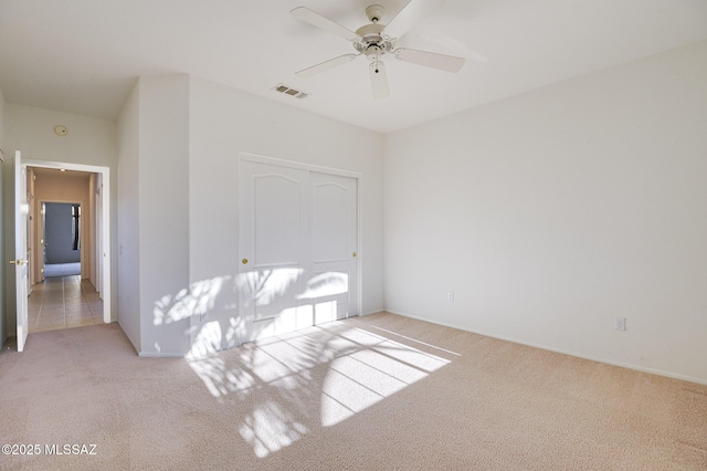 carpeted empty room with ceiling fan