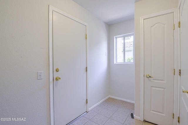 doorway to outside with light tile patterned floors