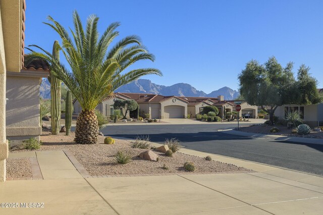 2283 E Buster Mountain Dr, Oro Valley, AZ 85755 - view of front facade featuring driveway, a mountain view, an attached garage, a residential view, and stucco siding