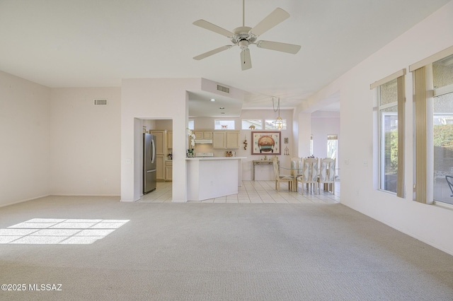 unfurnished living room featuring ceiling fan and light colored carpet