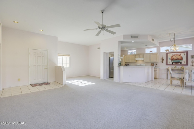 unfurnished living room featuring light colored carpet and ceiling fan