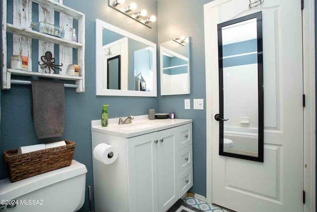 bathroom featuring vanity, toilet, and bathing tub / shower combination