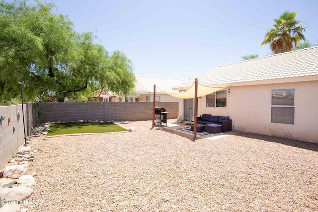 view of yard with a patio area, a fenced backyard, and an outdoor living space