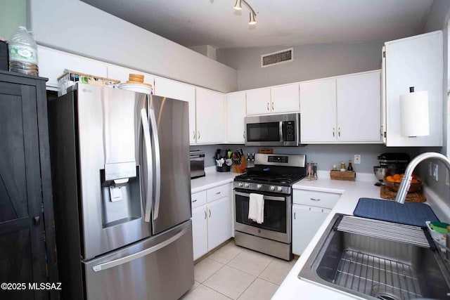 kitchen with white cabinetry and appliances with stainless steel finishes