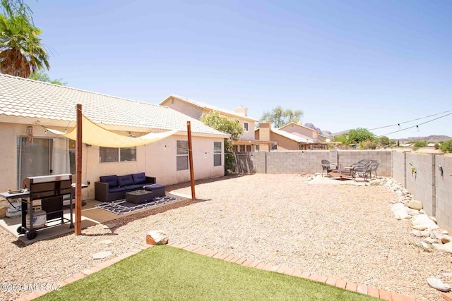 view of yard featuring a patio area, a fenced backyard, and an outdoor living space with a fire pit