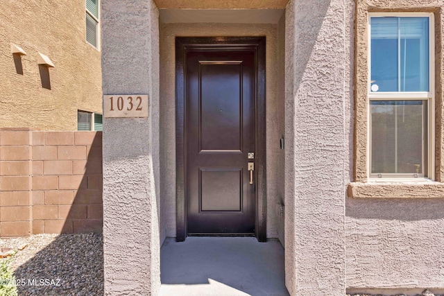 doorway to property with stucco siding