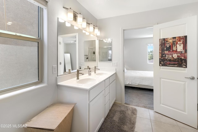 bathroom with lofted ceiling, tile patterned floors, and vanity