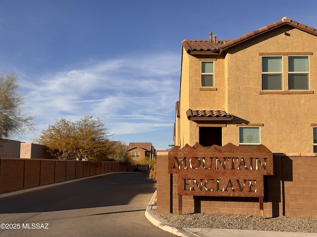 community / neighborhood sign with fence