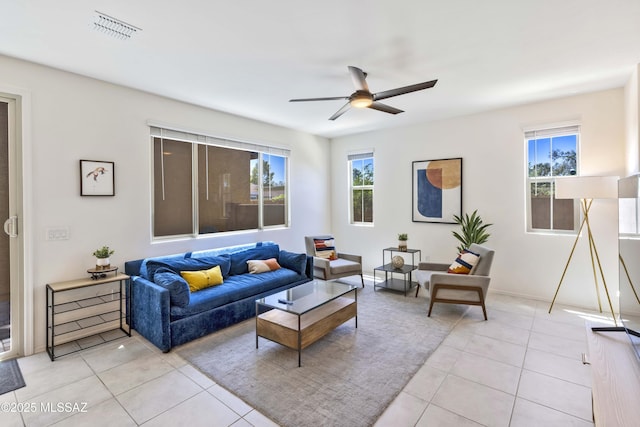 tiled living room featuring ceiling fan