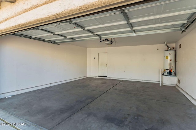 garage featuring water heater and a garage door opener