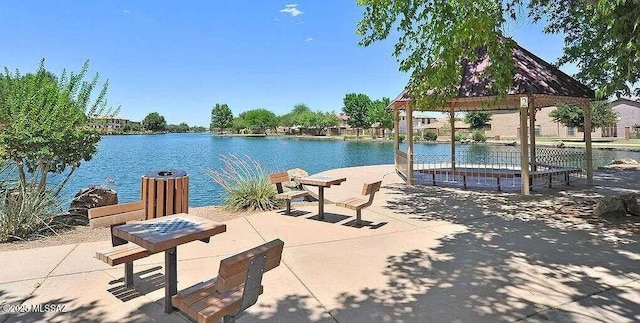 surrounding community featuring a gazebo, a water view, and a patio