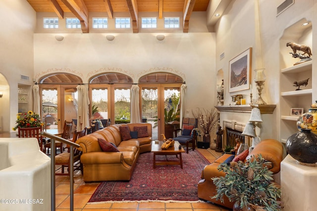 living room with built in features, visible vents, wood ceiling, beamed ceiling, and a fireplace