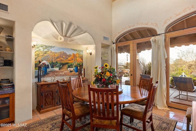 dining area with visible vents and light tile patterned floors