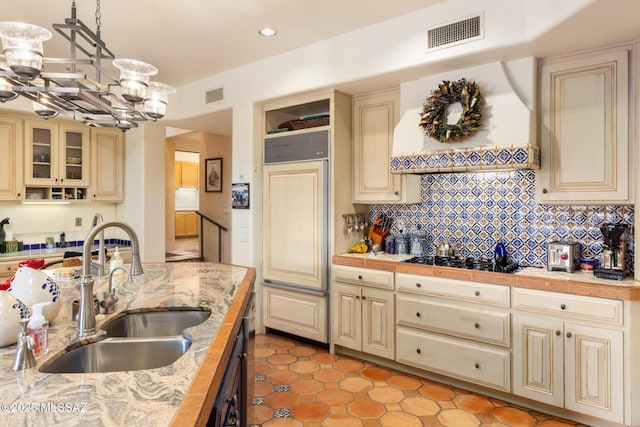 kitchen featuring cream cabinetry, visible vents, and a sink